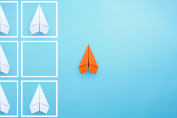 Business for solution concept with orange paper planes on blue background. think outside the box, different thinking, copy space