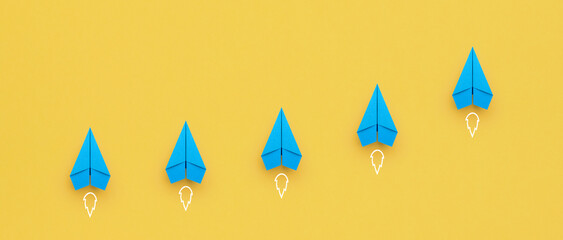 Blue paper plane on yellow background, Success in business growth concept