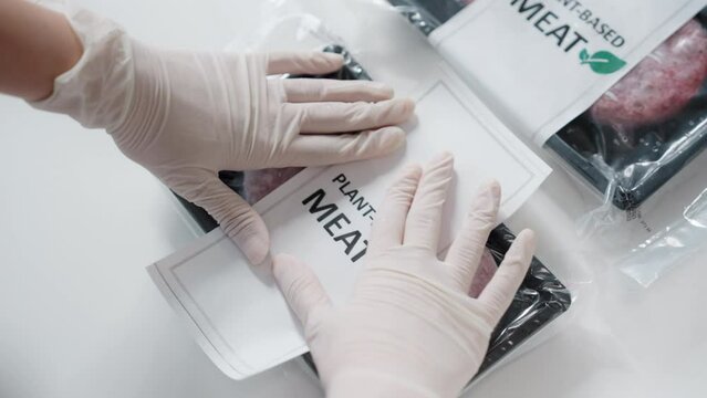 Small shop SME owner packing cool chilled beyond meat tray box send home parcel online order zero beef plant based soy bean meal. Raw patty cutlet clean food veggie vegan vendor diet retail eco store.