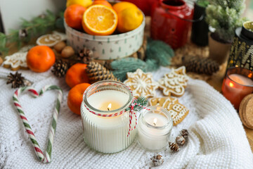 Burning candles in the New Year's interior and heart-shaped Christmas candies