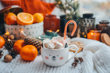 Cute cup of cocoa with marshmallows and christmas candy in new year atmosphere, aesthetic photo