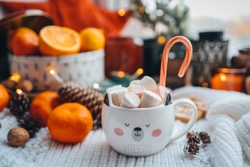 Cute cup of cocoa with marshmallows and christmas candy in new year atmosphere, aesthetic photo