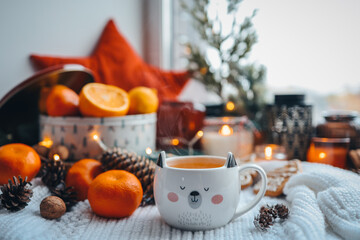 Cute cup of hot steaming tea in the New Year atmosphere, aesthetic photo