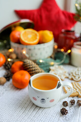 Obraz na płótnie Canvas Cute cup of tea in New Year's decor, cozy photo