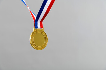 Blank gold medal on gray background