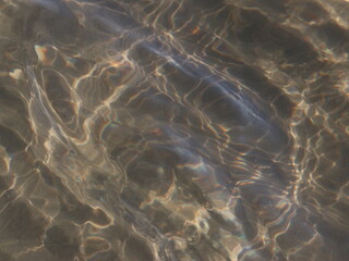 Fototapeta na wymiar A transparent sea wave running over the sand