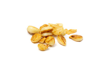 Fried garlic cloves pile closeup isolated. Roasted grilled garlic clove group on white background...