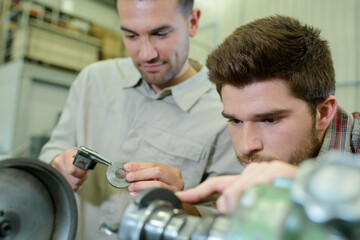 Fototapeta premium young man in technical vocational training with teacher