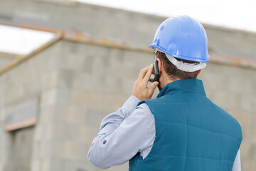 a construction worker with cellphone