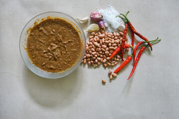 peanut sauce in a bowl on a concrete background