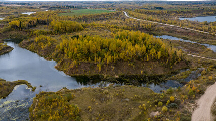 panoramic view from a drone of a network of lakes and islands with a yellow forest against the backdrop of autumn colors