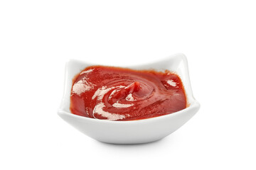A bowl filled with ketchup on a white background