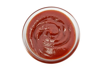 A bowl filled with ketchup on a white background