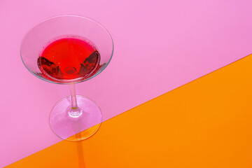 Glass of fresh cocktail on color background
