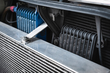 High performance engine oil cooler installed in front of vehicle. - obrazy, fototapety, plakaty