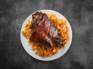 Schweinshaxe, in German cuisine, is a roasted ham hock (or pork knuckle). Roast pork knuckle with sauerkraut.
