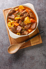 Irish stew stobhach is a stew native to Ireland that is traditionally made with root vegetables and meat closeup in the pot on the table. Vertical top view from above