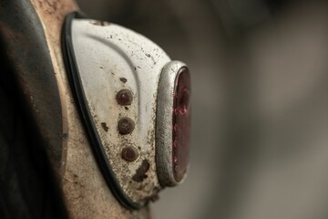 Close-up view of an old dirty machine's red lamp