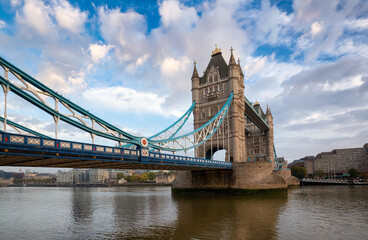 Fototapeta na wymiar Historic Bridge over River Thames and Cityscape Skyline during dramatic sunrise. Tower Bridge in City of London, United Kingdom. Travel Destination.