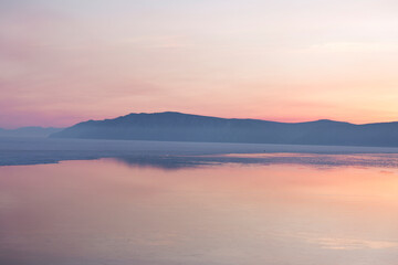 Naklejka premium Beautiful sunset on frozen lake Baikal. Winter landscape.