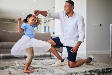 Black father, girl and being happy, dance and have fun together in living room. Dad, young female child and daughter doing quality time, dancing and in tutu dress for play, celebration and happiness.