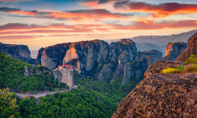 Fototapeta na wymiar Exciting summer view of famous Eastern Orthodox monasteries listed as a World Heritage site, built on top of rock pillars. Stunning evening scene of Kalabaka, Greece. Traveling concept background..