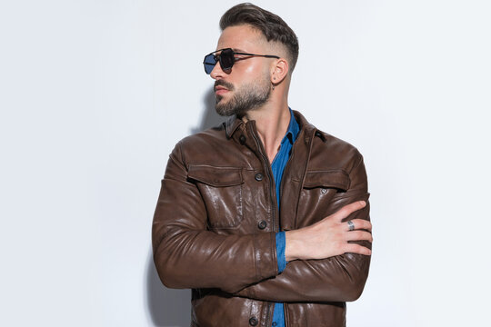 Handsome casual man crossing his arms, looking to side