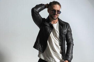 Fototapeta premium cool modern guy with hand behind neck looking away and posing
