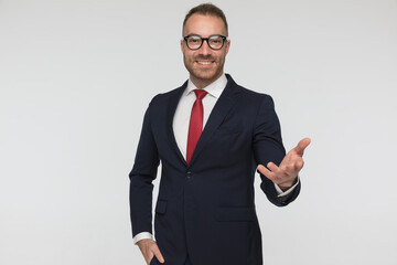 young happy businessman greeting with one open arm