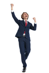 excited young man wearing suit holding fists in the air and cheering