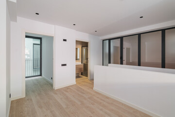 Interior of empty flat with doorways to bedroom and bathroom. White and clean room in refurbished apartment