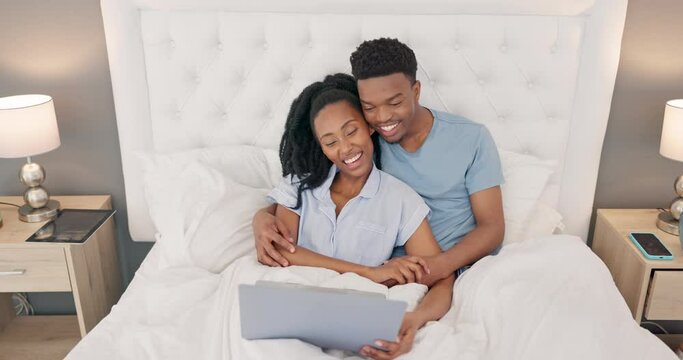 Laptop, Bed And Black People Couple With Movie At Night With Lamp, Furniture And Bedroom Luxury With Multimedia Technology. Love, Hug And Happy Woman Relax With Partner And Watch Film On Pc Together