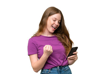 Young pretty woman over isolated background with phone in victory position