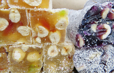 Traditional Turkish delicacies. Varieties of Turkish Delight with Pistachio.Turkish delight sweet cubes background. Lokum sprinkled with sugarin , display at a street food market