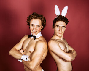 Easter and two friends. Funny couple in rabbit costumes.