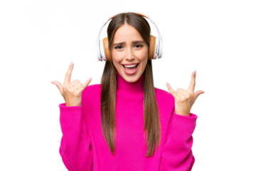 Young beautiful caucasian woman over isolated background listening music making rock gesture