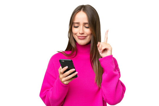 Young Beautiful Caucasian Woman Over Isolated Background Using Mobile Phone And Lifting Finger