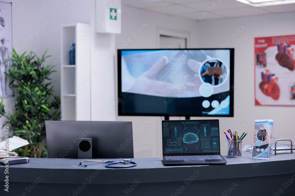 Poster laptop on medical clinic front desk showing brain scans. counter with medical articles, information 
