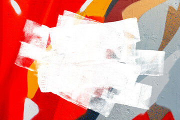 Closeup of colorful gray, orange, red urban wall texture with white white paint stroke. Modern pattern for design. Creative urban city background. Grunge messy street style background with copy space
