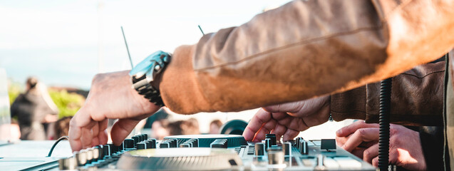 Horizontal banner or header with disc jockey hands playing music for tourist people at beach party outdoor - Live event, music and fun concept - Entertainment and party concept