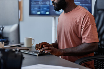 Fototapeta na wymiar Cropped shot of black man as software developer using computer in high technology office