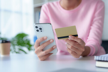 Close-up of woman enjoying the peace of mind of online shopping on mobile using credit card at home.