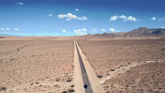 Car Traveling On Desert Road