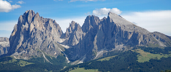 Majestic panoramic mountain view in the dolomites: Distinctive Sassolungo mountain group at gardena valley in south tyrol. Nature and holiday concept.
