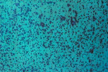 Abstract texture background of a macro photographed glazed ceramic stoneware surface in the color...