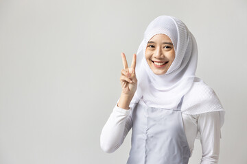 Confident happy smiling muslim woman catering business owner pointing 2 finger, v for victory hand gesture