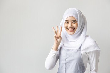 Confident happy smiling muslim woman catering business owner pointing up 3 fingers hand gesture