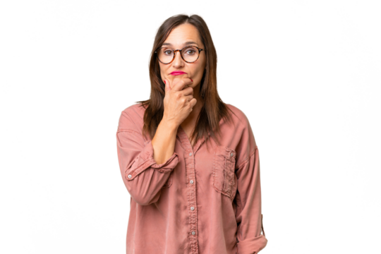 Middle-aged caucasian woman over isolated background having doubts