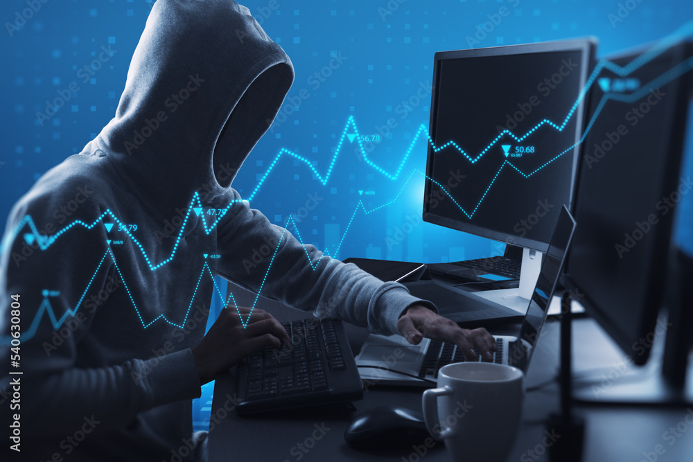 Fototapete Side view of hacker using computers at desktop with abstract glowing blue business graph hologram on blurry background. Economy, finance, hacking, data theft and digital money concept.