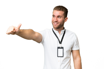 Young caucasian man with ID card isolated on green chroma background giving a thumbs up gesture